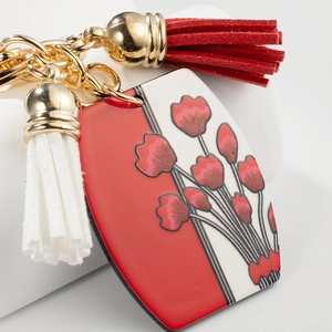 Porte-clés en métal à imprimé floral avec glands en cuir rouge et blanc élégants