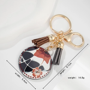 Tropical flower round keychain with brown tassels and gold lobster clasp 5.4cm wide