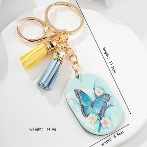 European butterfly keychain with blue pendant, dual tassels, and gold hardware dimensions