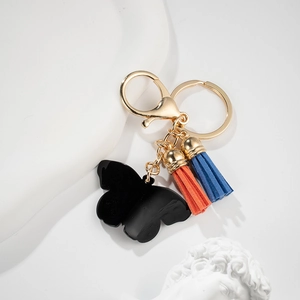 Butterfly keychain with black acrylic pendant and bicolor tassels on a white background