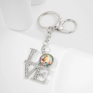 Close-up of silver LOVE keychain featuring sparkling rhinestones and a unicorn charm