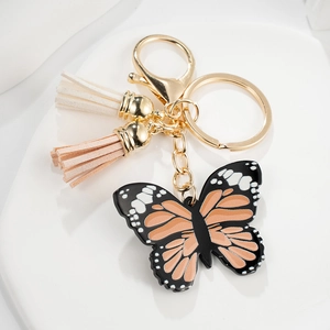 Exquisite butterfly keychain with orange wings, gold hardware, and colorful tassels