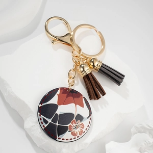 Chic geometric metal keychain with colorful floral pendant and stylish leather tassels