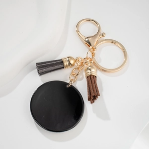 Fashionable geometric round pendant keychain with stylish grey and brown suede tassels