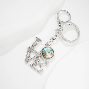 Silver metal LOVE keychain with sparkling rhinestones and hummingbird glass pendant