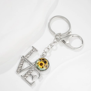 Silver LOVE keychain with sparkling crystals and a vibrant sunflower glass pendant