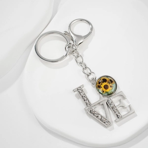 Detailed view of sunflower glass pendant with LOVE lettering and inlaid rhinestones