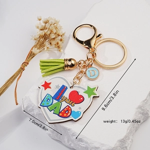 Father's Day heart keychain with I Love You Dad print and green tassel on stone
