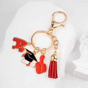 Detailed macro of graduation keychain with A+ charm, doctoral cap and red tassel