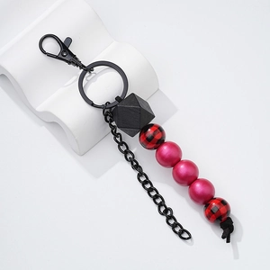 Detail of fashion wooden bead keychain with red checkered beads and black lobster clasp