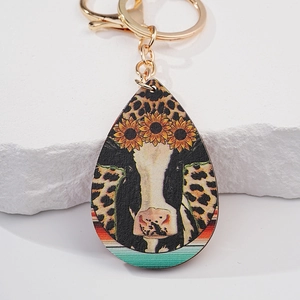 Water-drop faux leather keychain featuring cow print, sunflower and leopard details