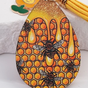 Creative honeycomb teardrop leather keychain with bee print, yellow fringe and flower charm