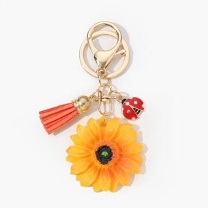 Portachiavi girasole con nappa arancione e ciondolo a forma di coccinella dorata