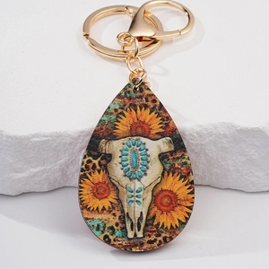 Detail of western bull skull and sunflower pattern keychain with gold clasp