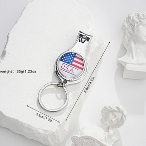 Detailed view of silver nail clipper keychain with USA flag emblem and dimension labels