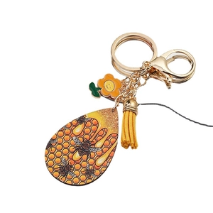 Creative honeycomb keychain with yellow tassel, sunflower charm, and bee motif pendant