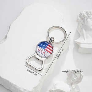 Macro detail of USA flag bottle opener keychain on white stone with Greek sculpture