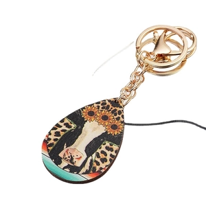 Cow head teardrop wooden keychain with leopard print and sunflower on a gold keyring