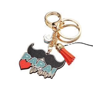 Father's Day mustache keychain with Papa Te amo text and red leather tassel in gold finish