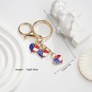 Detail showing American flag heart keychain with dimensions 7.4x3.3cm and lobster clasp