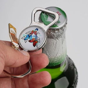 Macro shot of butterfly pattern keychain opener with beer glass charm detail