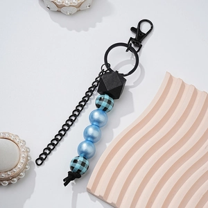 Detailed view of fashion wood bead keychain with blue beads and leopard print accents