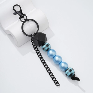 Detail view of fashion wooden beaded keychain with black geometric bead and blue accents