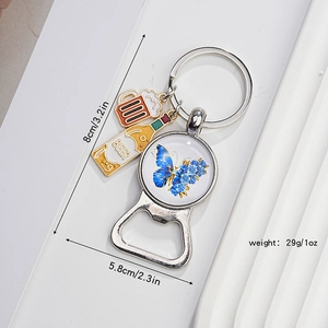 Macro shot of butterfly pendant keychain with beer bottle charms and integrated bottle opener