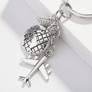 Silver metal world map airplane keychain with New York Paris travel charms
