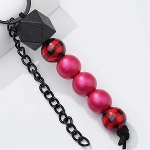 Fashionable beaded wooden keychain with buffalo plaid patterns and pink beads on black chain