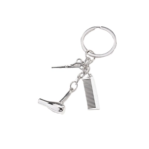 Polished silver hair stylist keychain set featuring scissors, comb, and hair dryer charms