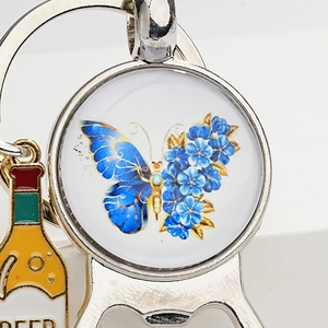 Detail of vintage butterfly gem keychain with metal beer bottle opener and engraving