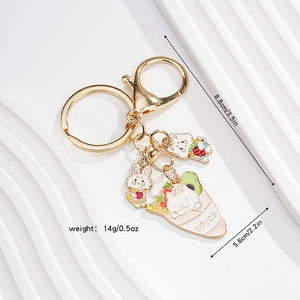 Detailed view of cute rabbit and bear pendants on a golden metal keychain with UPICK logo