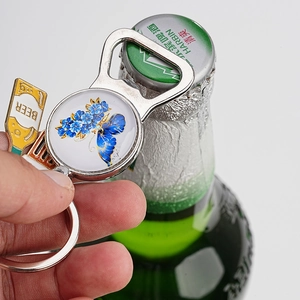 Macro shot of vintage butterfly metal bottle opener keychain used to open a beer bottle