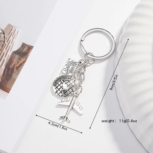 Silver travel keychain with globe and airplane charms showing size and weight details