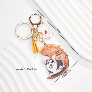 Detail view of acrylic dog keychain with golden hardware, yellow tassel, and wooden charm