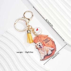 Detailed view of dog acrylic keychain with yellow tassel and golden lobster clasp