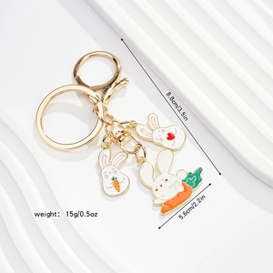 Detailed view of golden bunny charms with enamel finish and specific size dimensions