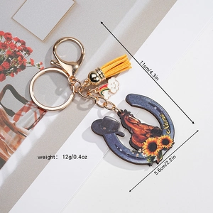 Detail of horseshoe keychain with sunflower horse print, yellow tassel and dimensions