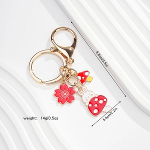 Detailed size view of a cute enamel bunny keychain with cherry blossom and mushroom charms