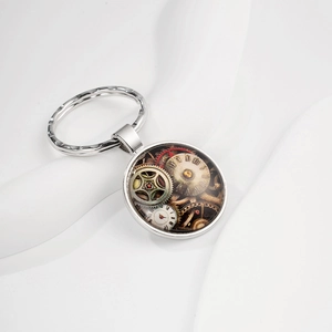 Macro detail of vintage steampunk gear clock keychain with roman numerals on white silk