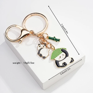 Detail view of cartoon panda enamel keychain with dimensions 7.4cm by 5.6cm and weight 14g