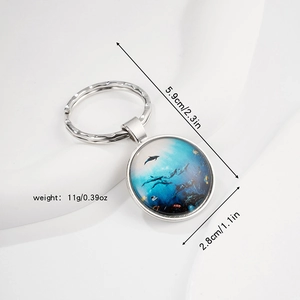 Elegant ocean world glass gem keychain with dolphin pattern and blue sea motif