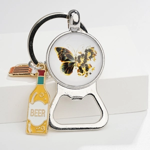 Detail of vintage butterfly bottle opener keychain with beer bottle and glass charms