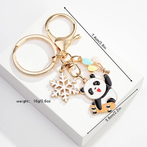 Detail view of panda on skateboard keychain with size specs and metal charms