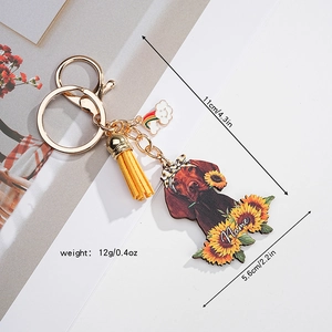 Detailed macro view of custom sunflower acrylic dog keychain with yellow tassel