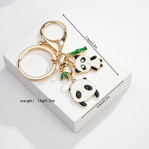 Detail of panda keychain set with gold metal finish and green bamboo charms