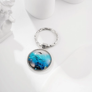 Ocean world time gem keychain with dolphin print and blue sea motif in round glass lens
