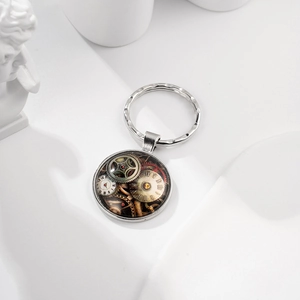 Steampunk keychain detail showing intricate clockwork gears inside a silver metal pendant
