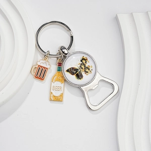 Detail of vintage butterfly bottle opener keychain with colorful enamel beer pendants